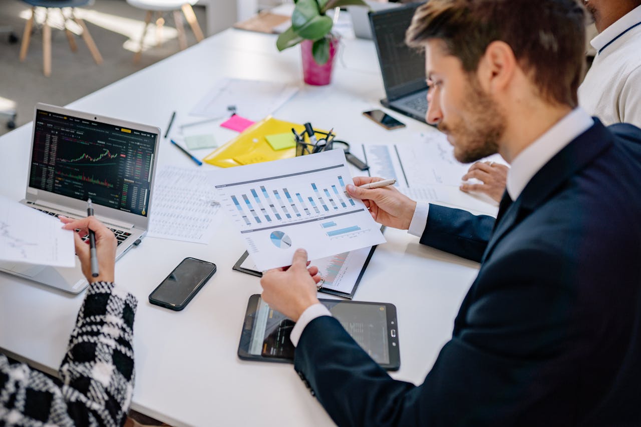 Business team reviewing graphs and data in an office setting.